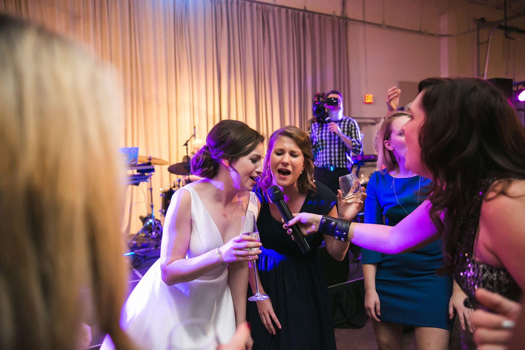 Guests dancing in front of the stage at a reception